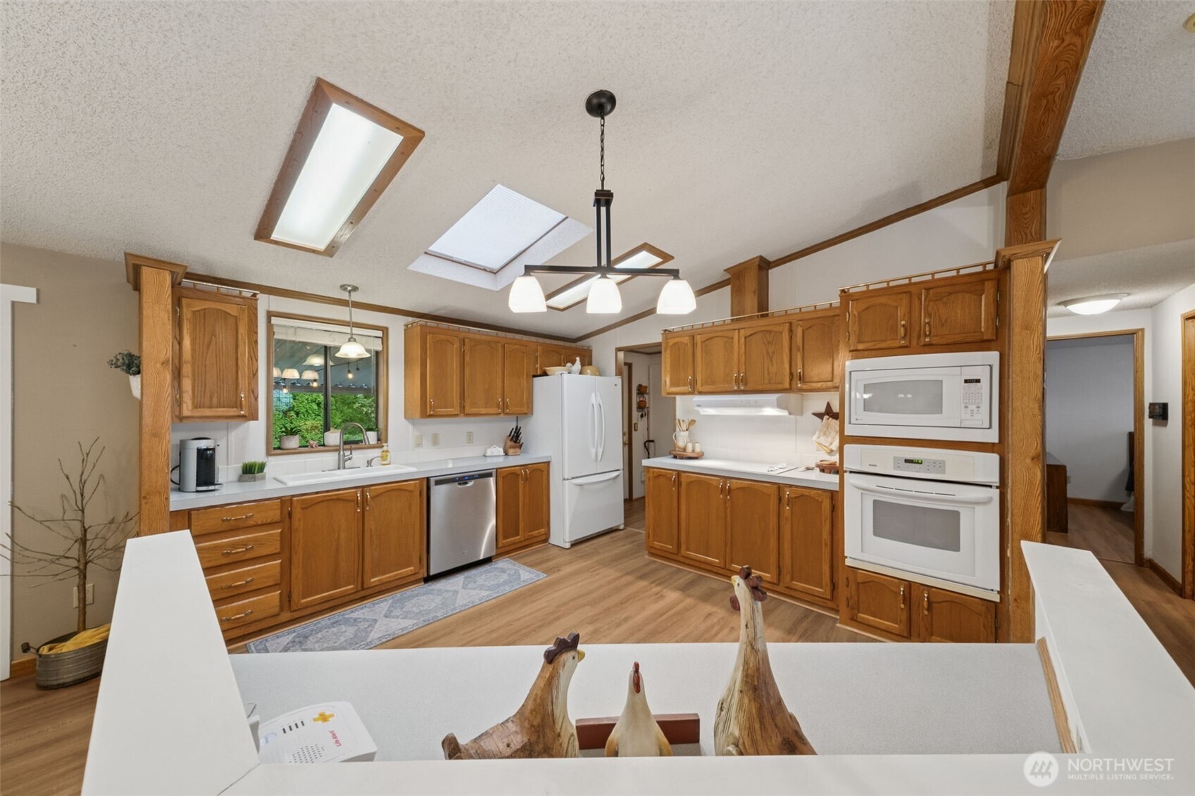 2350 Rincon Avenue Enumclaw, WA 98022 - Photo 12 of 31 a kitchen with stainless steel appliances granite countertop a sink and dishwasher a stove with wooden floor