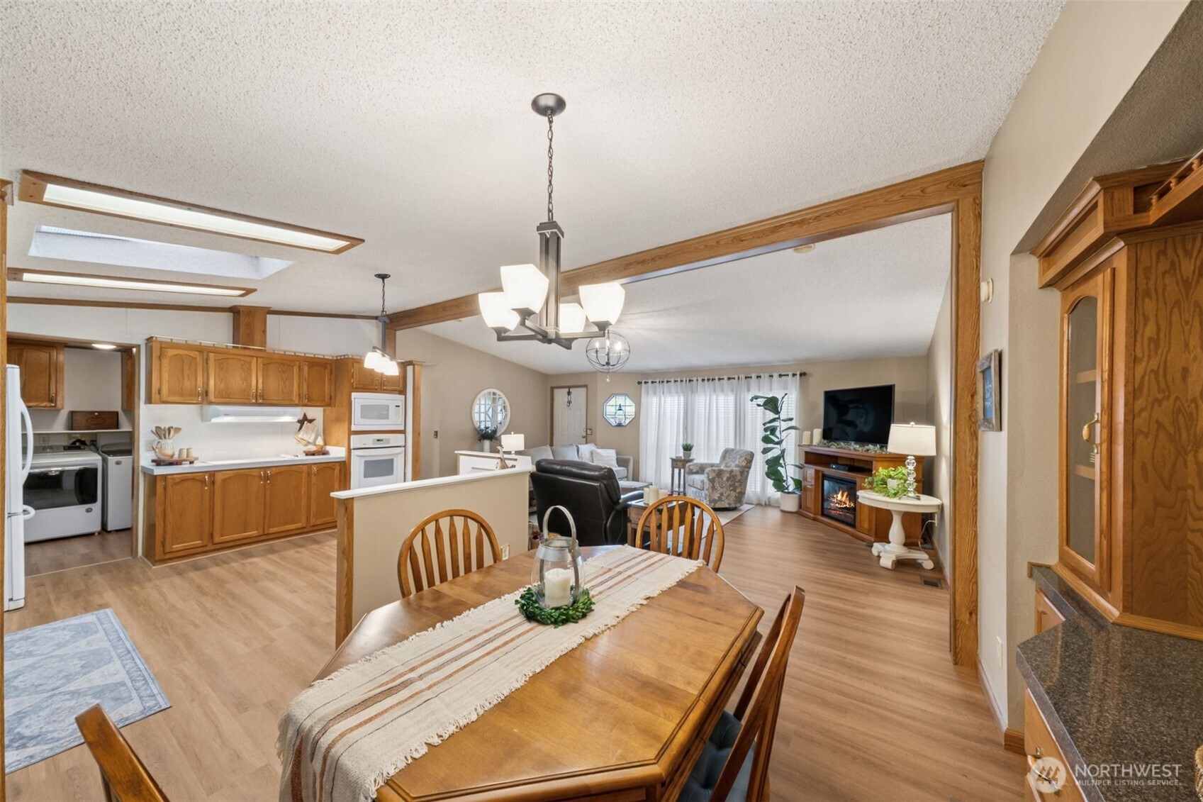 2350 Rincon Avenue Enumclaw, WA 98022 - Photo 15 of 31 a living room with furniture kitchen view and a wooden floor