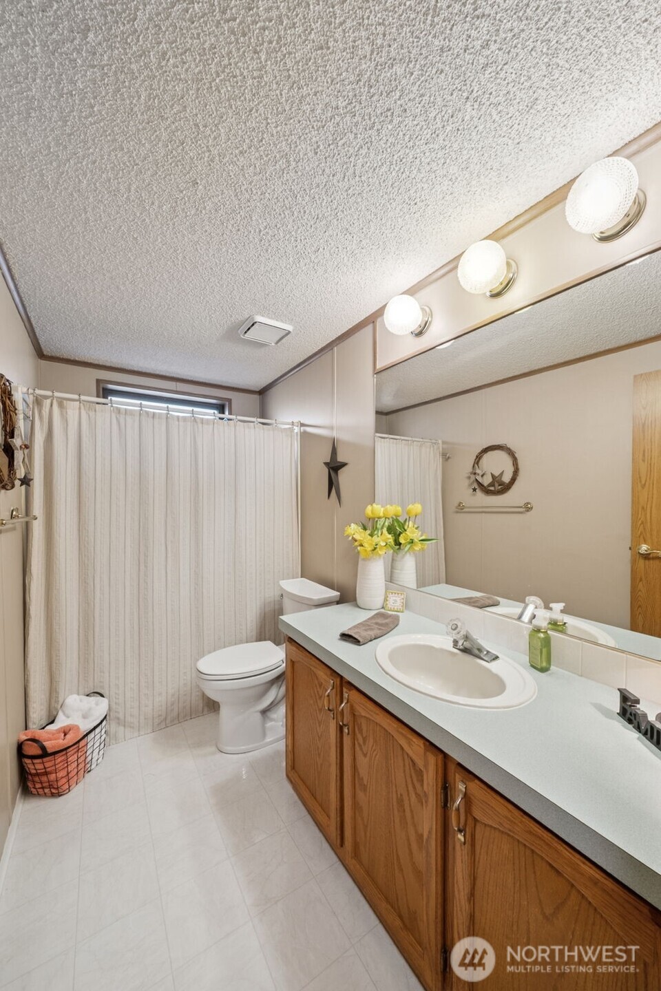 2350 Rincon Avenue Enumclaw, WA 98022 - Photo 23 of 31 a bathroom with a granite countertop sink and a mirror