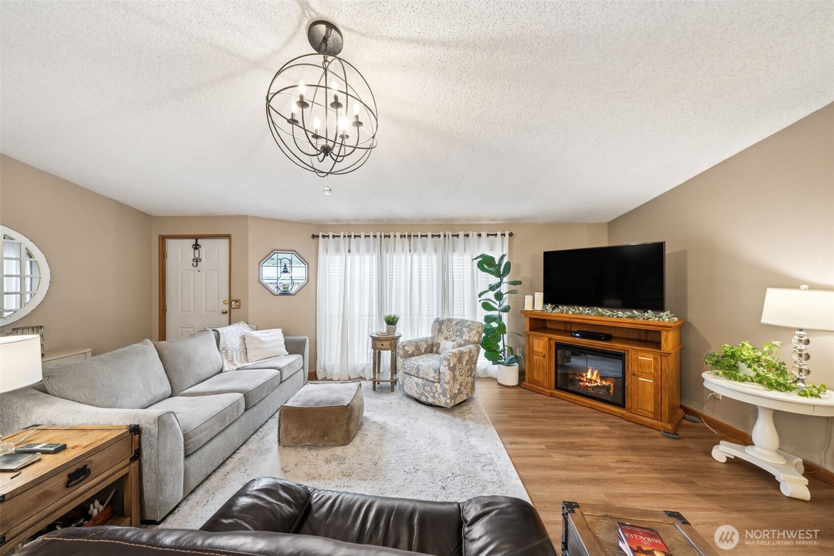 2350 Rincon Avenue Enumclaw, WA 98022 - Photo 6 of 31 a living room with furniture a flat screen tv and a fireplace