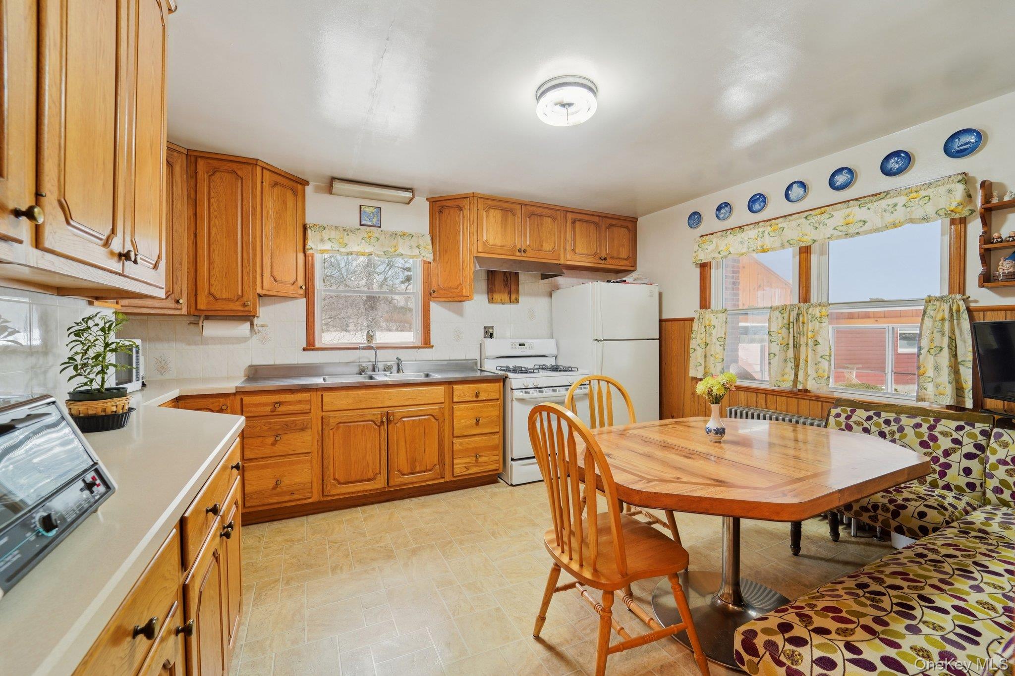 350 Barrett Hill Road Mahopac, NY 10541 - Photo 3 of 21 a kitchen with stainless steel appliances granite countertop a table chairs sink and cabinets