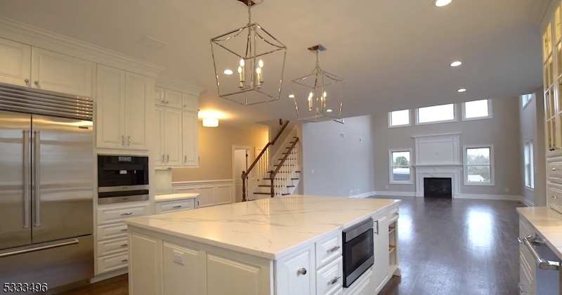 1831 Washington Valley Road Bridgewater, NJ 08836 - Photo 11 of 43 a kitchen with a sink a counter top space stainless steel appliances and a chandelier