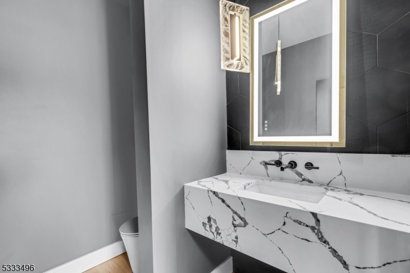 1831 Washington Valley Road Bridgewater, NJ 08836 - Photo 20 of 43 a bathroom with a sink a mirror and a toilet