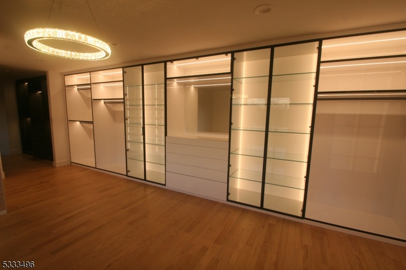 1831 Washington Valley Road Bridgewater, NJ 08836 - Photo 26 of 43 en empty room with sliding door and wooden floor