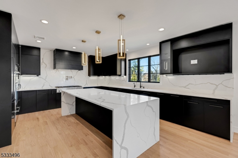 1831 Washington Valley Road Bridgewater, NJ 08836 - Photo 7 of 43 a kitchen with stainless steel appliances kitchen island granite countertop a sink and a microwave