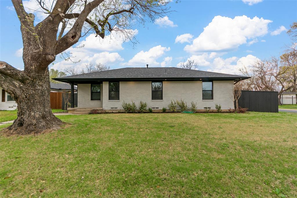 2945 Healey Drive Dallas, TX 75228 - Photo 2 of 38 a front view of a house with a garden