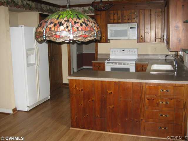 2506 Tanglebrook Road Midlothian, VA 23112 - Photo 5 of 11 a kitchen with stainless steel appliances granite countertop a sink and a refrigerator