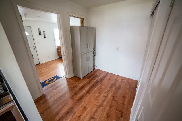 a view of front door with wooden floor
