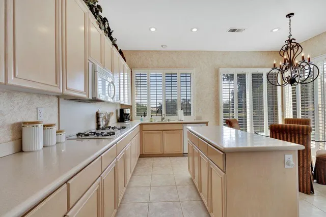 a kitchen with stainless steel appliances granite countertop a sink and cabinets