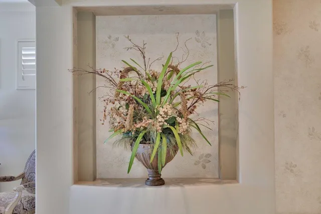 a vase of flowers sitting on a floor