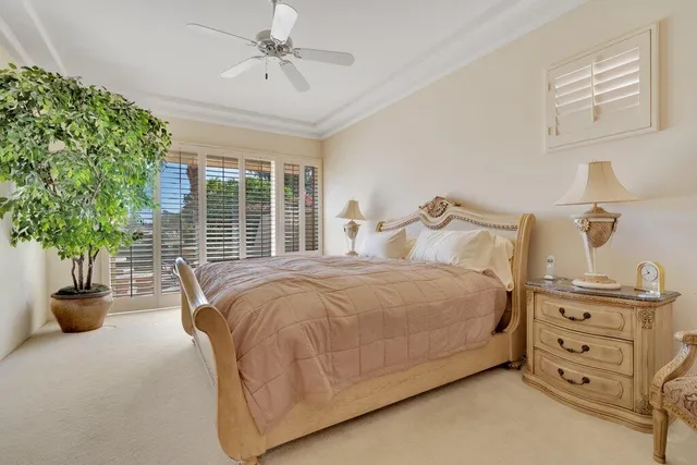 a bedroom with a bed and ceiling fan
