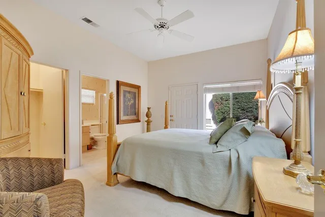 a bedroom with a bed couch and a window