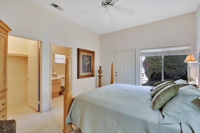 a bedroom with a bed and a large mirror