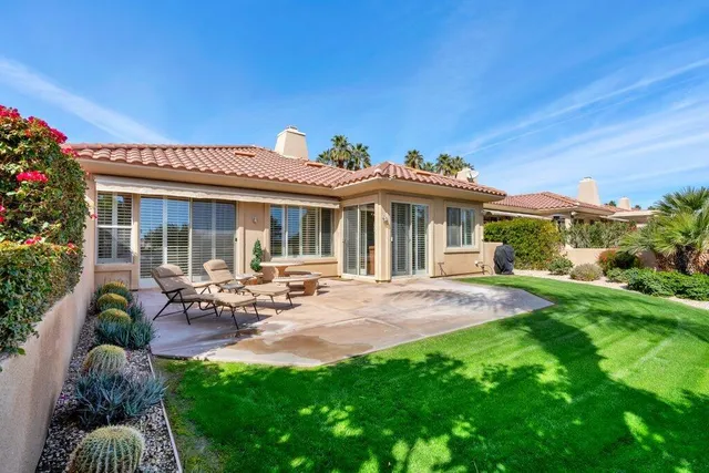 a view of a house with backyard porch and sitting area