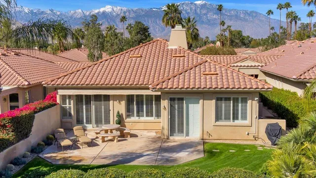 a front view of a house with a yard fire pit and outdoor seating