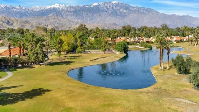 a view of a swimming pool with mountains in the background