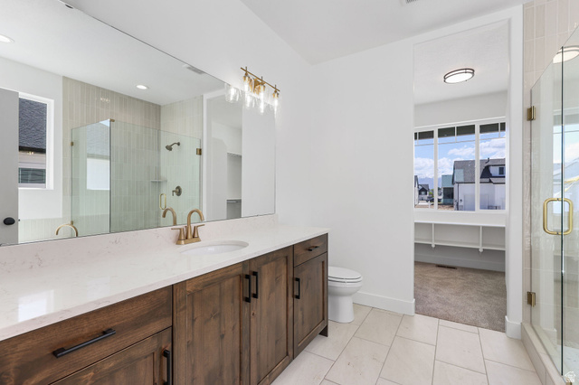 1144 South 4475 West West Point, UT 84015 - Photo 16 of 30 Bathroom featuring a wide vanity with a light-toned countertop, a full-width mirror, and a rectangular under-mount sink