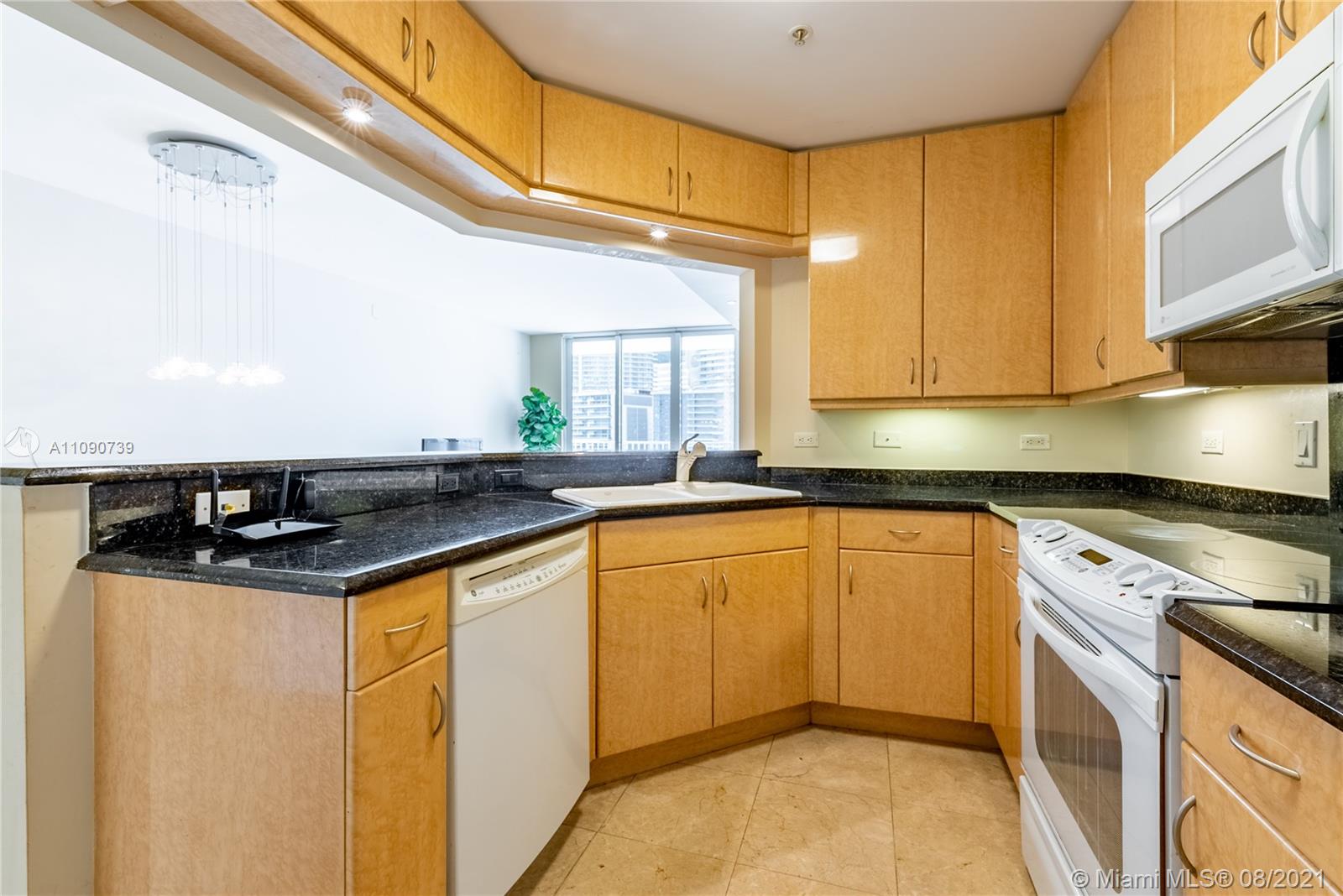 801 Brickell Key Boulevard, Unit 806 Miami, FL 33131 - Photo 11 of 20 a kitchen with stainless steel appliances granite countertop a sink a stove and a refrigerator