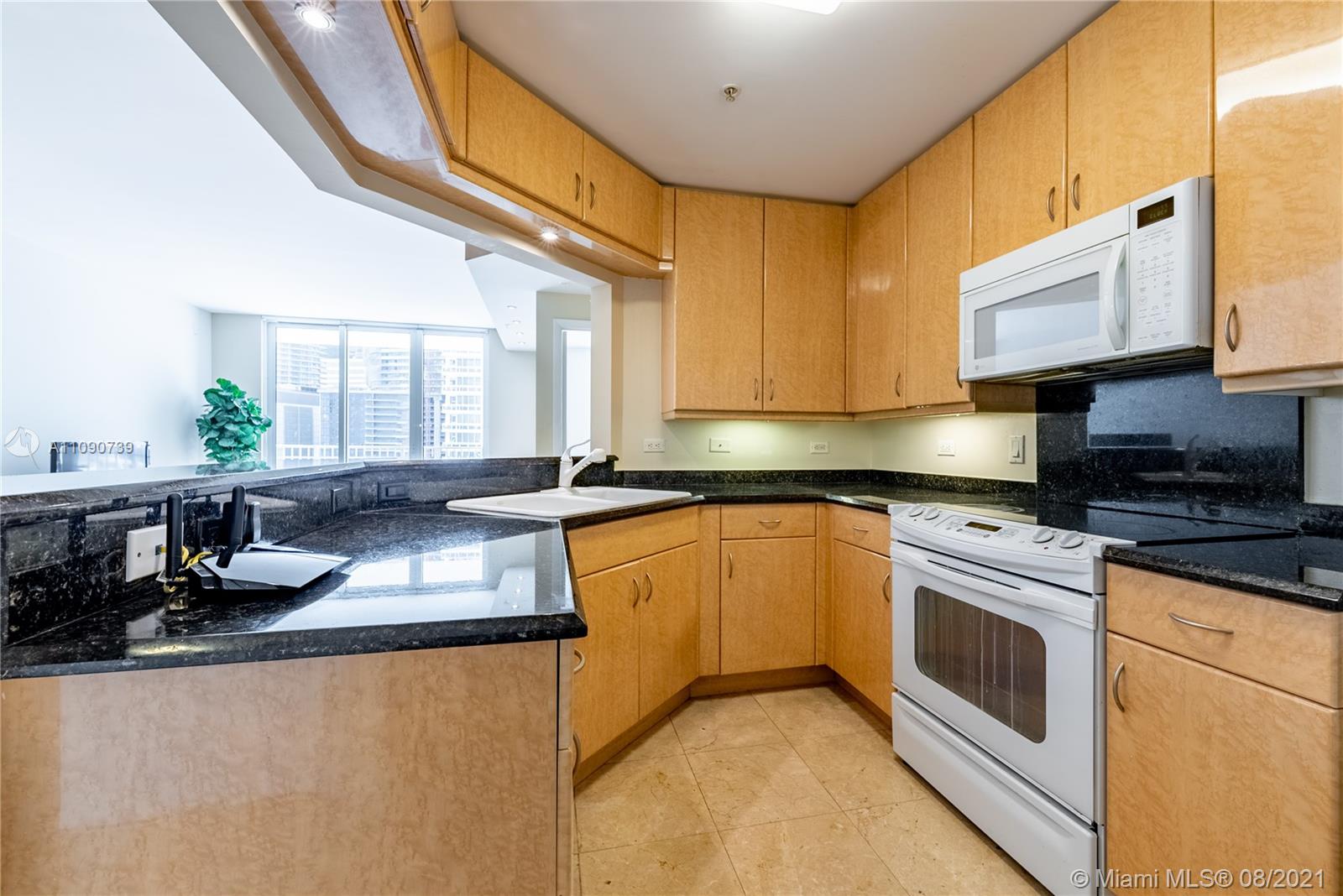 801 Brickell Key Boulevard, Unit 806 Miami, FL 33131 - Photo 12 of 20 a kitchen with stainless steel appliances granite countertop a sink stove and cabinets