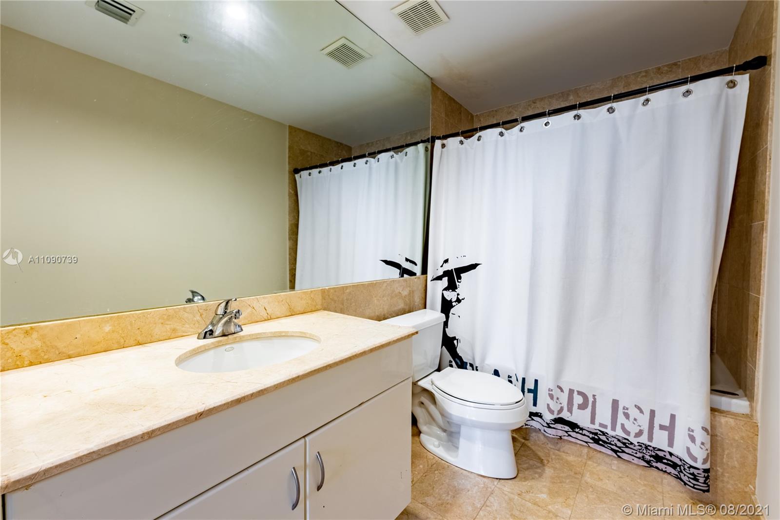 801 Brickell Key Boulevard, Unit 806 Miami, FL 33131 - Photo 10 of 20 a bathroom with a sink a toilet and a mirror