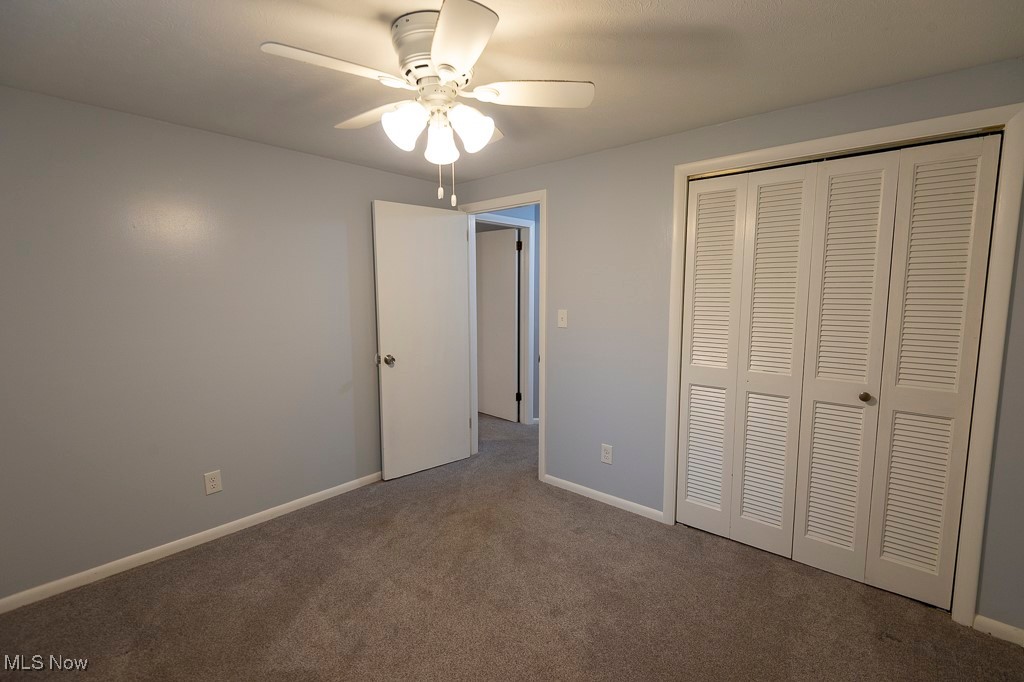 11819 Sheldon Road Mantua, OH 44255 - Photo 16 of 46 Unfurnished bedroom 1 featuring ceiling fan, a closet, and carpet floors