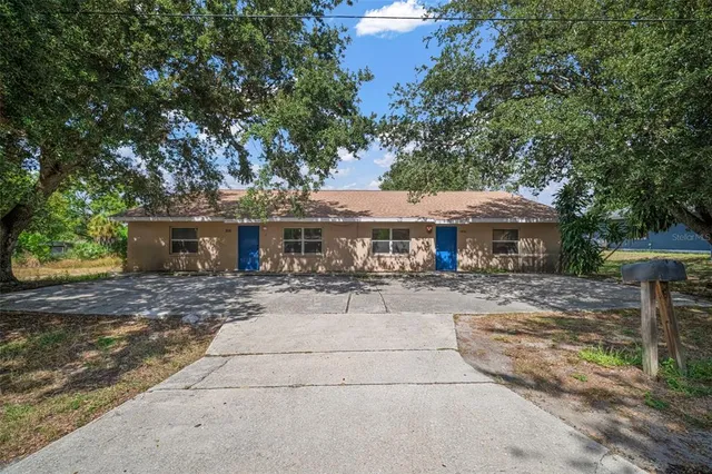 a front view of a house with yard patio and seating space