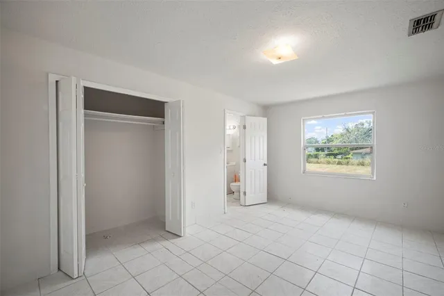 an empty room with white walls and tiles