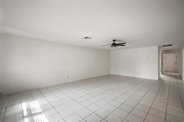 a view of a livingroom with a ceiling fan and window