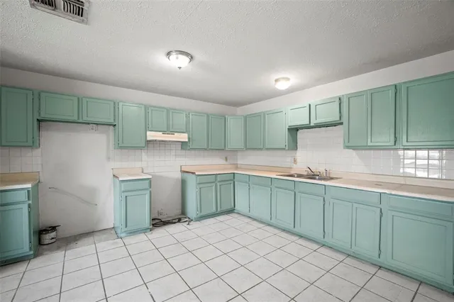 a kitchen with a sink and cabinets