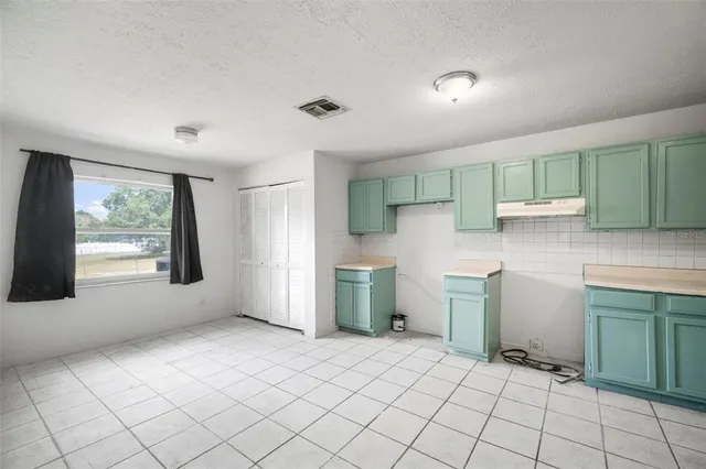 a kitchen with a sink and a refrigerator