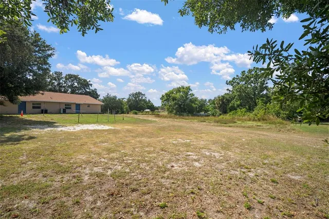 a front view of a house with a garden and tree