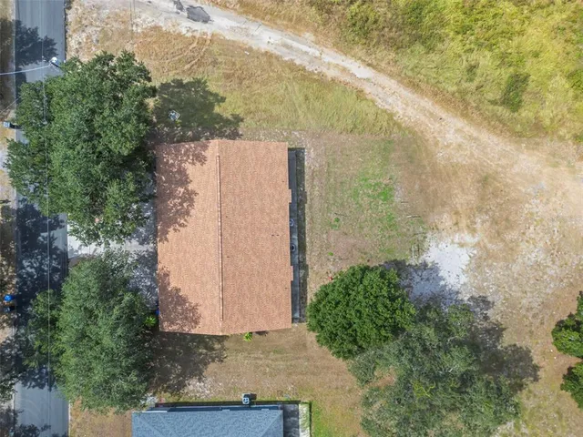 an aerial view of a houses with a yard