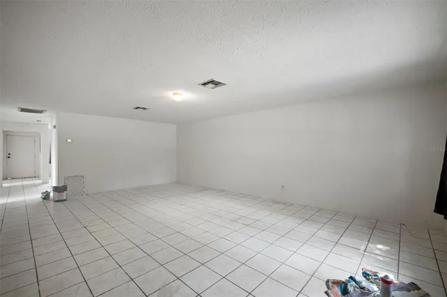 a view of an empty room and wooden floor