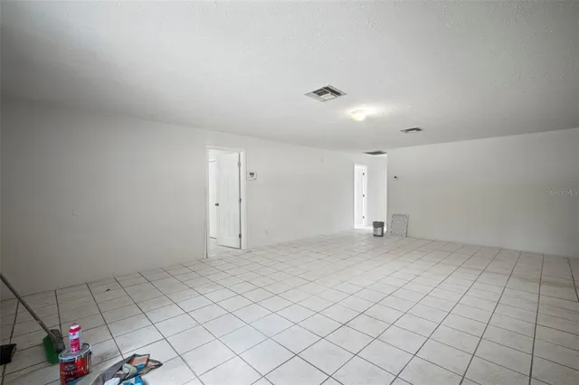 a view of an empty room with a fan
