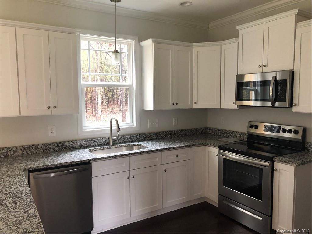2105 Cedar Road York, SC 29745 - Photo 4 of 12 a kitchen with granite countertop white cabinets appliances a sink and a window