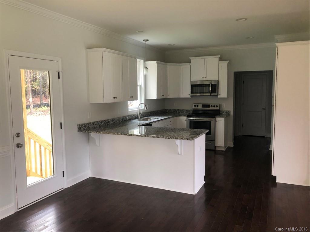2105 Cedar Road York, SC 29745 - Photo 5 of 12 a kitchen with stainless steel appliances granite countertop a stove a sink and a refrigerator