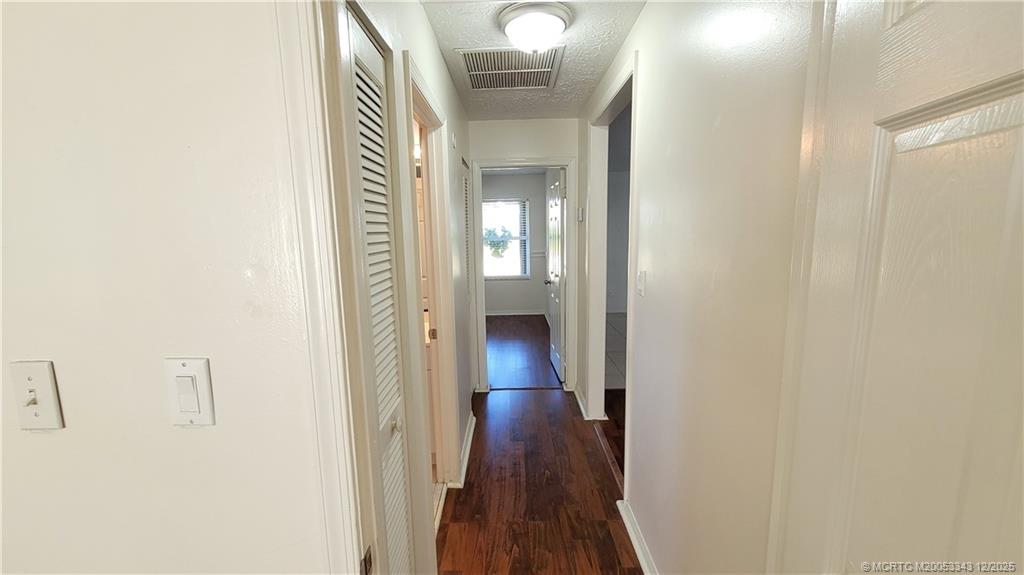 2149 Southeast Dolphin Road Port St. Lucie, FL 34952 - Photo 12 of 25 a view of a hallway with wooden floor
