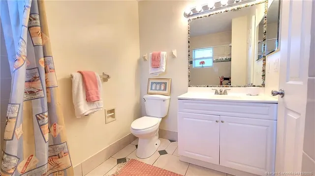 a bathroom with a sink toilet vanity and tub