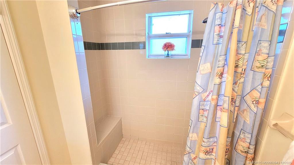 2149 Southeast Dolphin Road Port St. Lucie, FL 34952 - Photo 17 of 25 a bathroom with a bathtub and shower