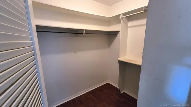 a view of walk in closet with wooden floor