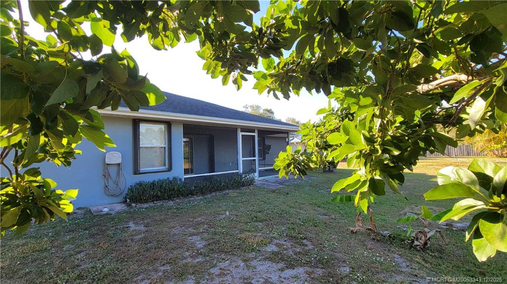 2149 Southeast Dolphin Road Port St. Lucie, FL 34952 - Photo 21 of 25 a front view of a house with a garden
