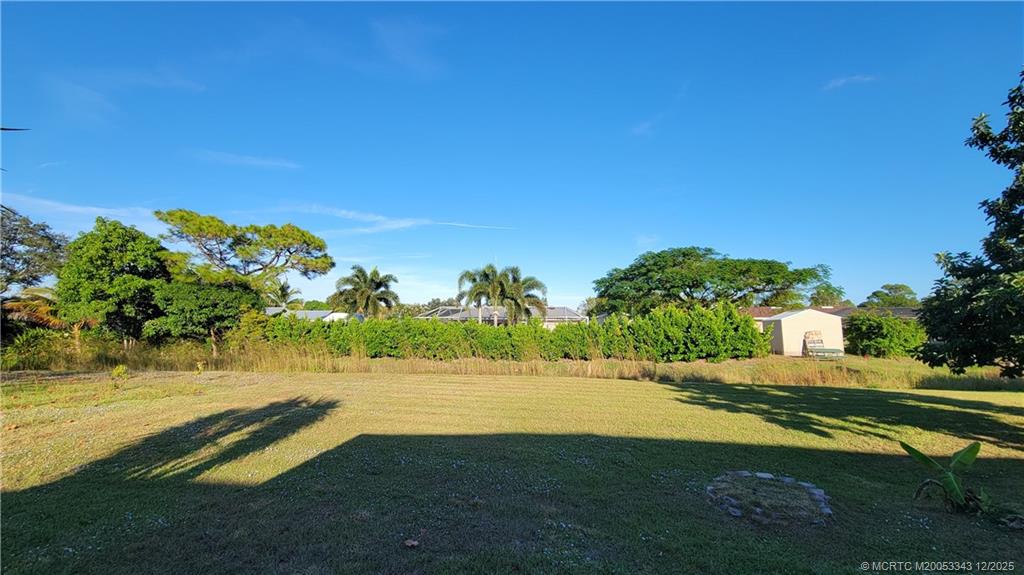 2149 Southeast Dolphin Road Port St. Lucie, FL 34952 - Photo 22 of 25 a view of a lake with a big yard
