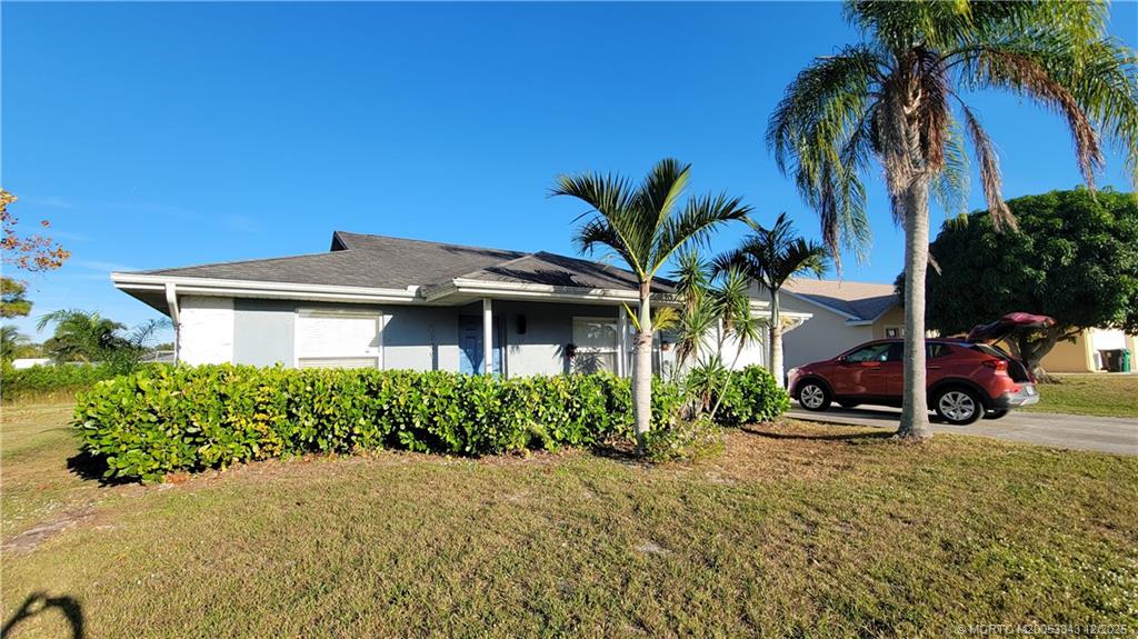 2149 Southeast Dolphin Road Port St. Lucie, FL 34952 - Photo 3 of 25 a front view of a house with a yard