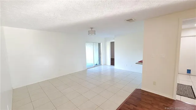 a view of an empty room and wooden floor