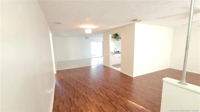 a view of a kitchen with wooden floor