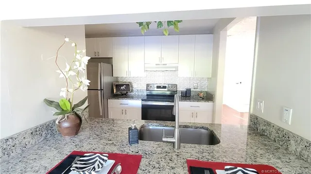 a kitchen with a refrigerator and a stove