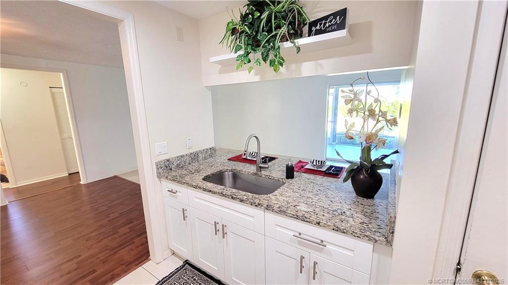 2149 Southeast Dolphin Road Port St. Lucie, FL 34952 - Photo 9 of 25 a kitchen with a sink and a potted plant