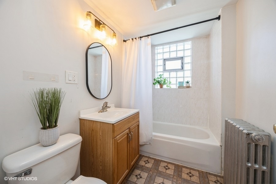 1309 Maple Avenue Berwyn, IL 60402 - Photo 13 of 17 a bathroom with a toilet sink vanity tub and mirror
