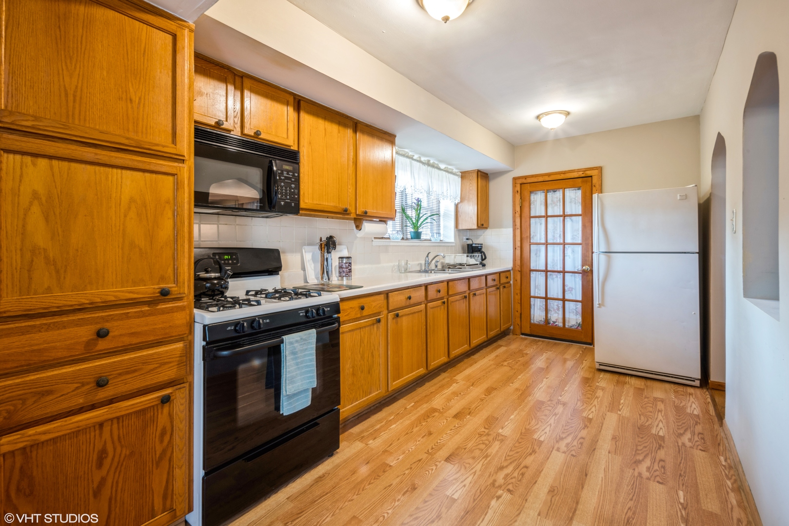 1309 Maple Avenue Berwyn, IL 60402 - Photo 7 of 17 a kitchen with stainless steel appliances granite countertop a stove a sink and a refrigerator
