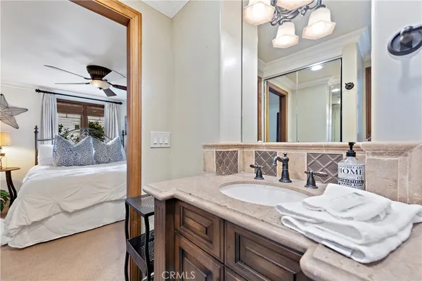 a spacious bedroom with a large bed and a chandelier